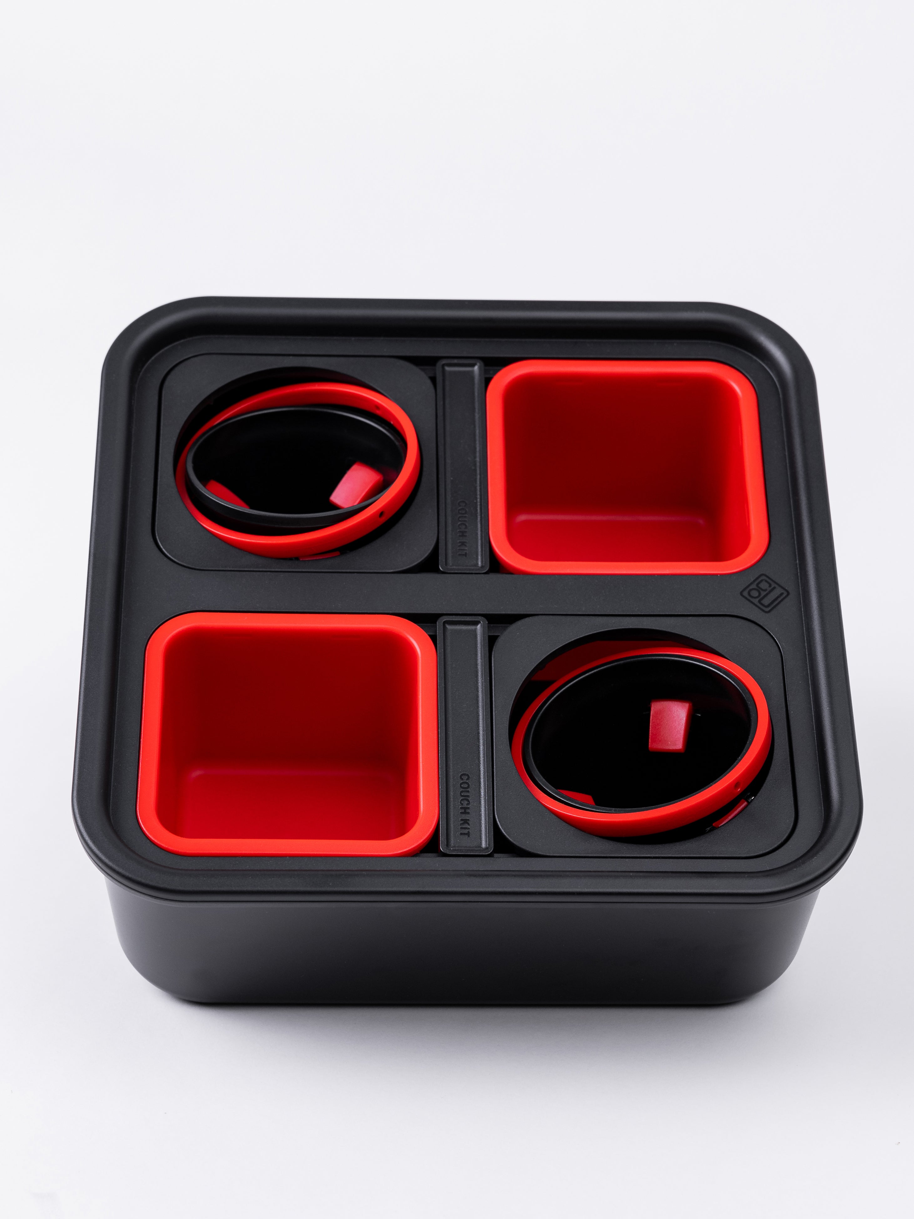 Black and red compartmentalized container on a white background